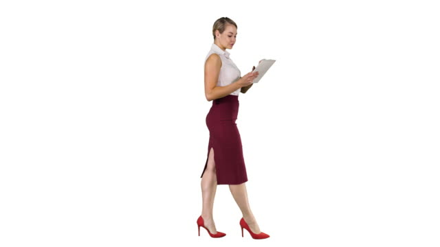 Businesswoman-using-electronic-tab-walking-on-white-background