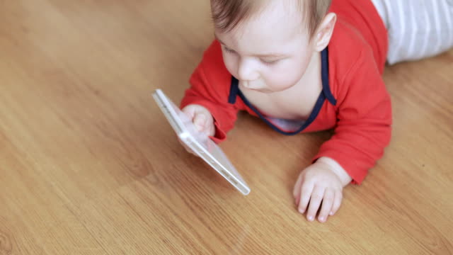 Baby-boy-playing-with-a-smartphone