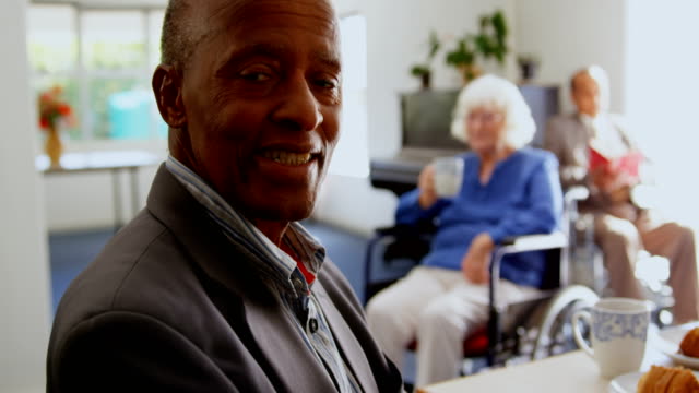 Side-view-of-African-American-senior-man-smiling-in-nursing-home-4k