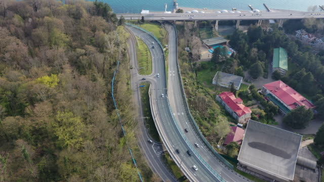 Aerial-video-shooting.-Transport-interchange-along-the-black-sea-coast-in-Sochi.-Evening-light-over-the-horizon-of-the-sea.-Panorama-shooting.-Blue-water.-resort-of-Russia.