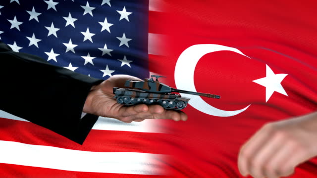USA-and-Turkey-officials-exchanging-tank-money,-flag-background,-country-defense