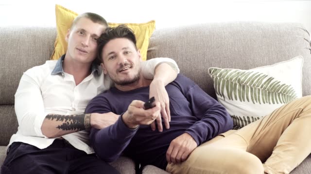Gay-couple-relaxing-on-couch.-Watching-tv.