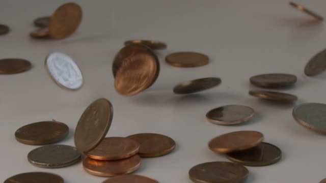 Extreme-slow-motion-of-a-bunch-of-coins-flipping-on-a-table