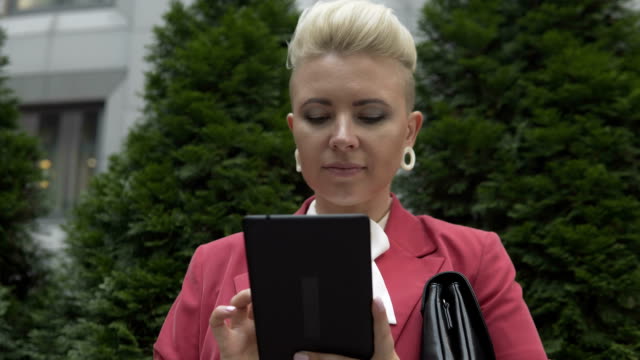 Geschäftsfrau-benutzt-ein-Tablet-auf-der-Straße