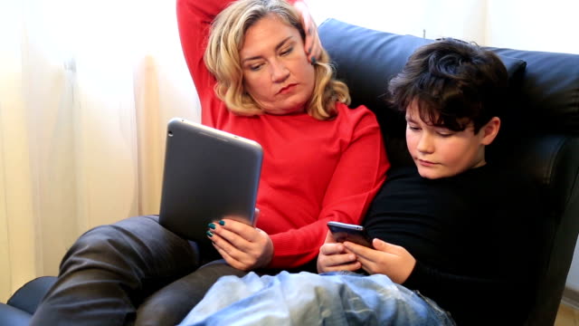 Mother-and-son-using-digital-equipment