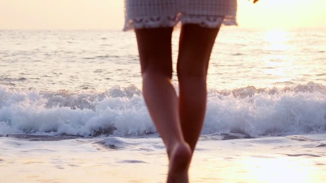 legs-young-Caucasian-female-healthy-outdoor-lifestyle-walking-beach-coast-tropical-living-travel-barefoot-ocean-shallows