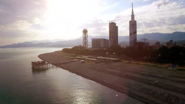 Light-haze-surrounding-Batumi-seafront-with-buildings-at-back,-late-afternoon