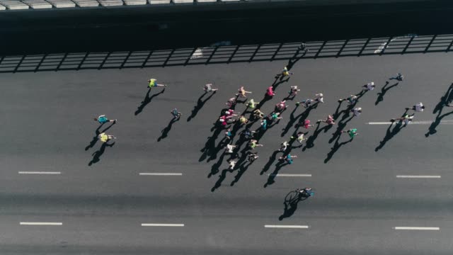 4k-Aerial-drone-fooage.-Marathon-running-on-street.-Following-Group-of-athletes.-Top-view