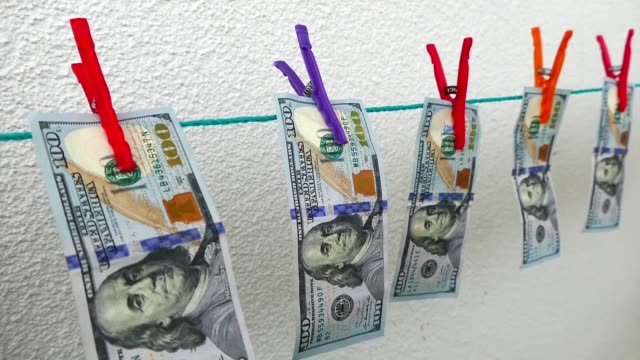 usa-dollars-lined-up-with-pegs,