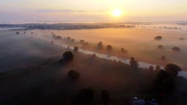 Aerial-footage-video-of-foggy-morning.-Flying-over-the-Desna-river.-Sunrise-time.-Kyiv-region,-Ukraine.