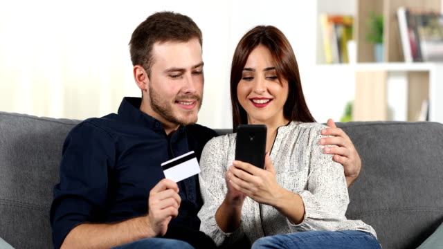 Couple-shopping-online-with-credit-card-at-home