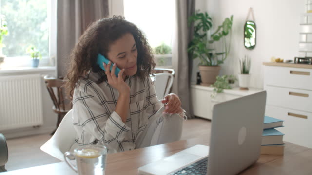Young-woman-using-mobile-phone-at-home.