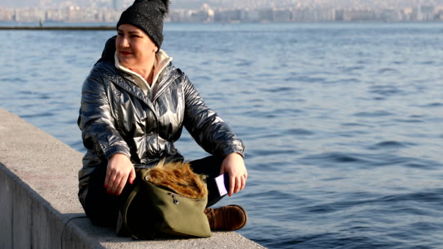 Woman-using-smartphone-near-the-sea