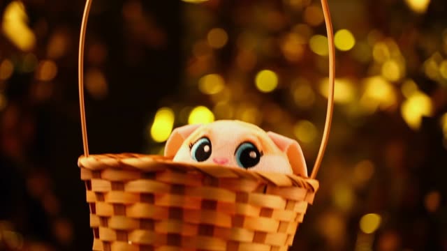 toy-rabbit-basket-gold-bokeh-hd-footage