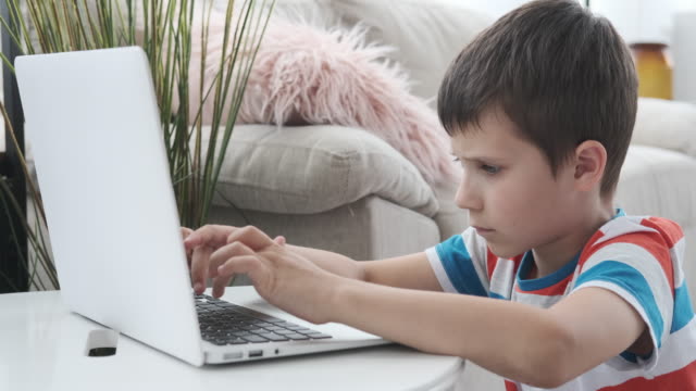 Boy-e-learning-on-laptop-at-home