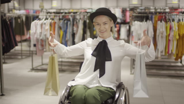 Paraplegic-Woman-Posing-with-Shopping-Bags-in-Clothing-Store