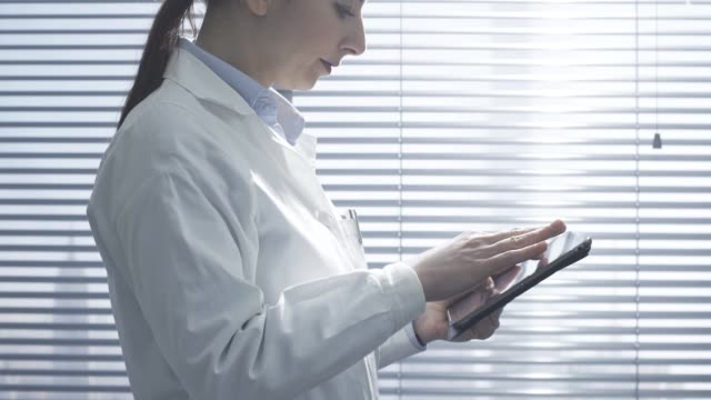 Professional-female-doctor-using-a-digital-tablet