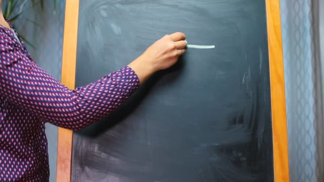 hand-draws-chalked-euro-sign-on-blackboard
