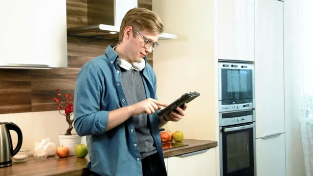 Young-man-using-digital-tablet-chatting-in-social-network
