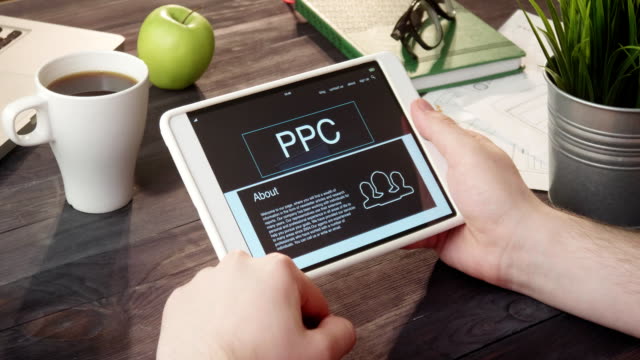 Reviewing-PPC-info-using-digital-tablet-at-desk