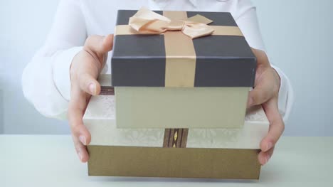 Gift-box-in-the-hands-of-business-women.-Happy-woman-isolated