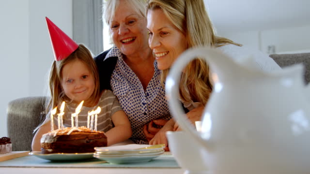 Multi-generation-family-celebrating-birthday-on-sofa-4k
