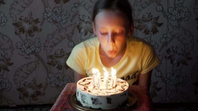 young-girl-blowing-out-birthday-candles