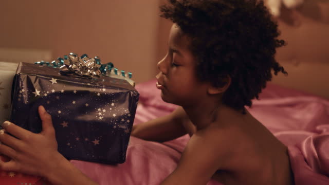 Child-hugs-gift-boxes.