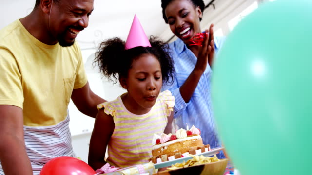 Family-celebrating-a-birthday-in-kitchen-at-home