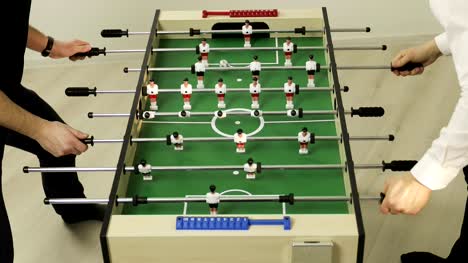4K-Two-happy-friends-play-table-football.