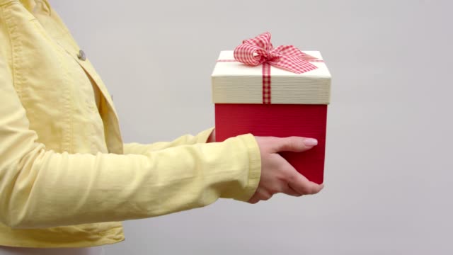 A-girl-holds-out-a-gift-from-right-to-left