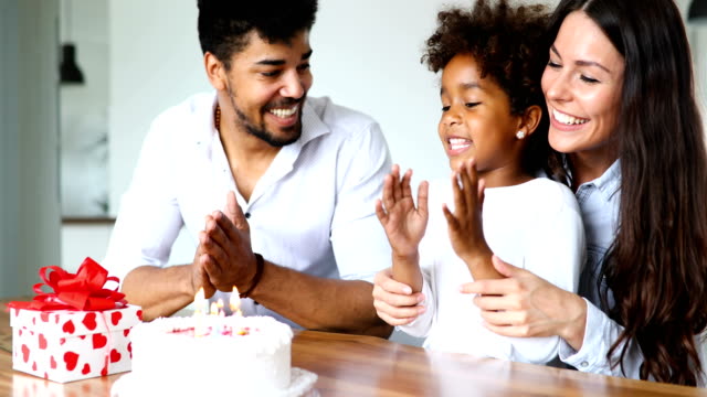 Happy-family-celebrating-birthday-of-their-child