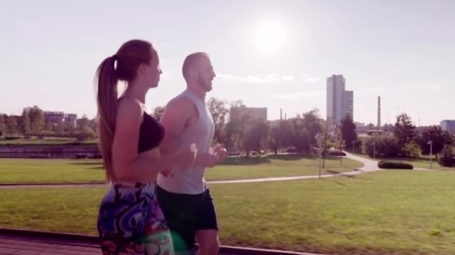 man-and-woman-running-in-city-park