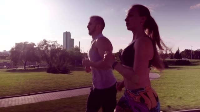 man-and-woman-running-in-city-park