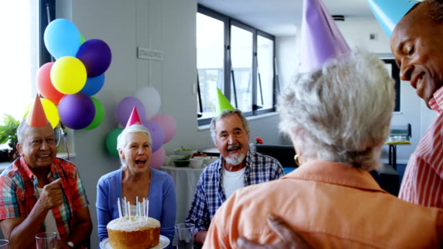 Senior-woman-celebrating-her-birthday-with-friends-4k