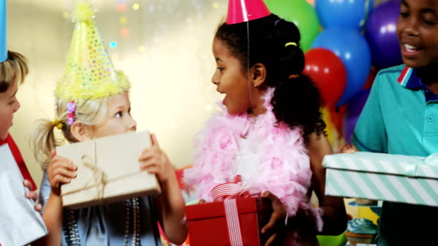 Kids-holding-gift-boxes-during-birthday-party-4k