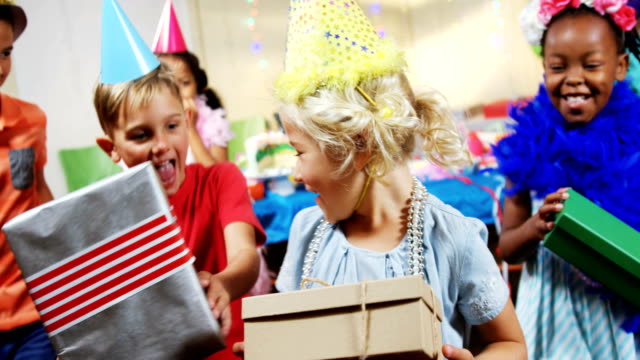 Birthday-girl-receiving-gift-boxes-from-friends-4k