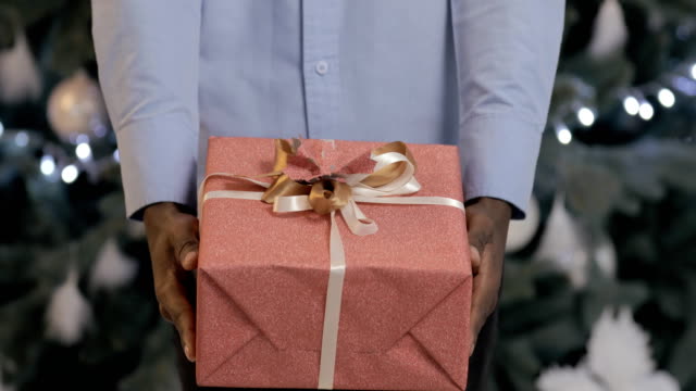 Black-man-presents-a-gift-box