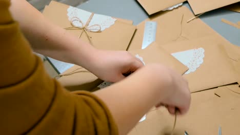Professional-woman-decorator-working-with-kraft-paper-and-wrapping-envelope