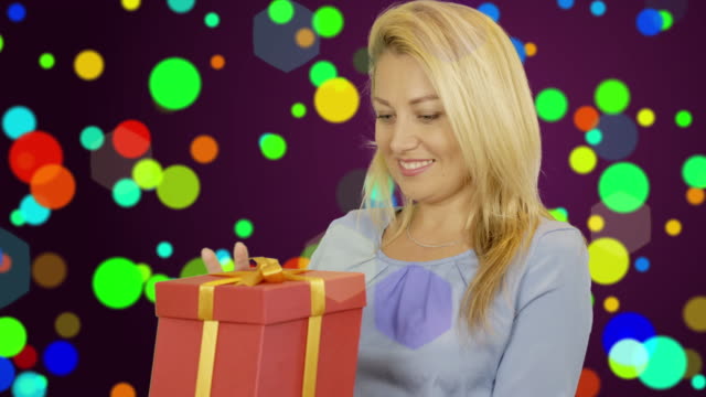 A-smiling-girl-receives-a-gift