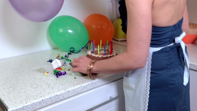 Woman-take-birthday-party-cake-and-go-away-from-kitchen