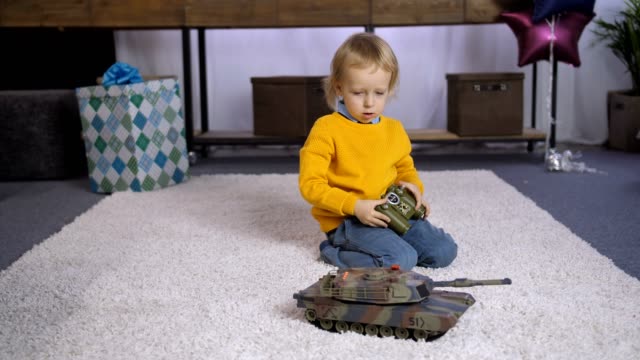 Serious-boy-learning-to-play-remote-control-toy