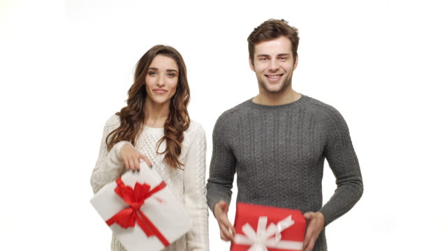 4k-young-couple-showing-and-giving-present-to-camera-on-white-isolated-background.