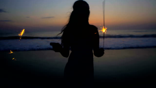 Silhouette-of-Asian-Indian-woman-celebrating-with-sparklers