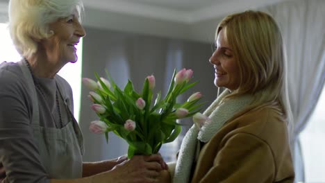 Woman-Hugging-Mother-and-Giving-her-Spring-Flowers