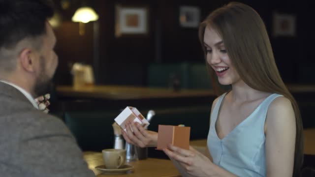 Woman-Opening-Present-on-Date