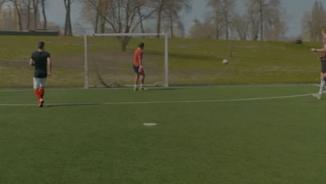 Young-footballer-shooting-on-goal-during-training