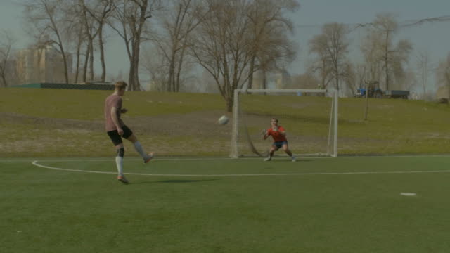 Young-soccer-player-taking-a-shot-on-goal