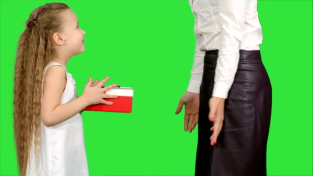 Young-charming-mother-and-her-cute-daughter-opened-Christmas-gifts-on-a-Green-Screen,-Chroma-Key