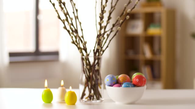 easter-eggs,-willow-and-candles-burning-at-home